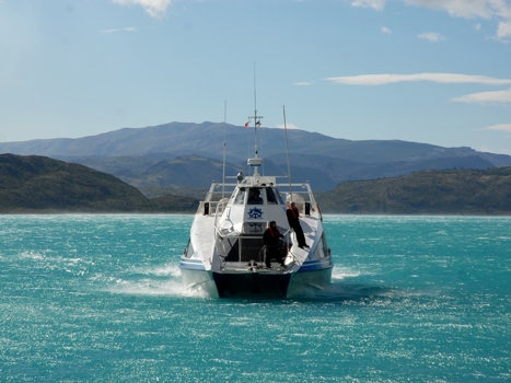 Båt färdas över gröna vatten, Patagonien